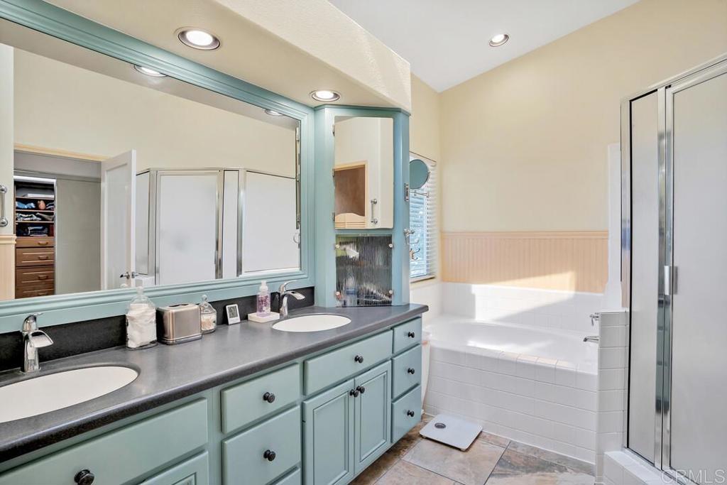 4617 Cyrus Way Oceanside, CA 92056 - Photo 33 of 63 a bathroom with a double vanity sink and a mirror