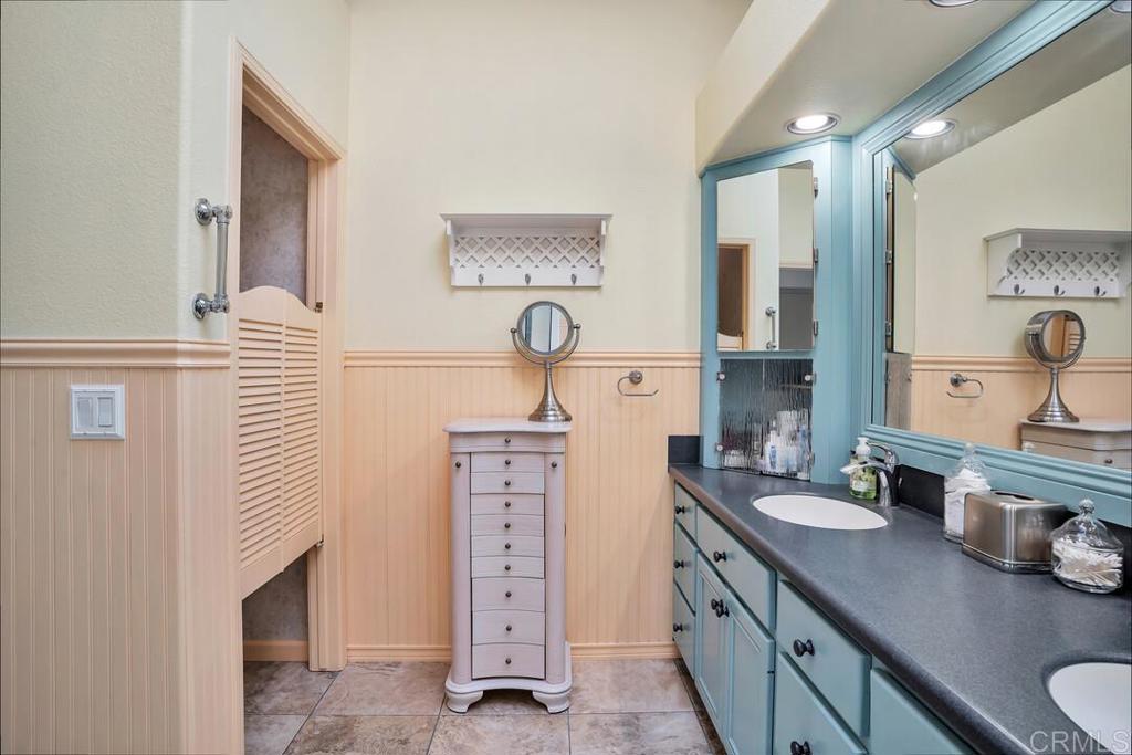 4617 Cyrus Way Oceanside, CA 92056 - Photo 34 of 63 a spacious bathroom with a sink double vanity and a mirror