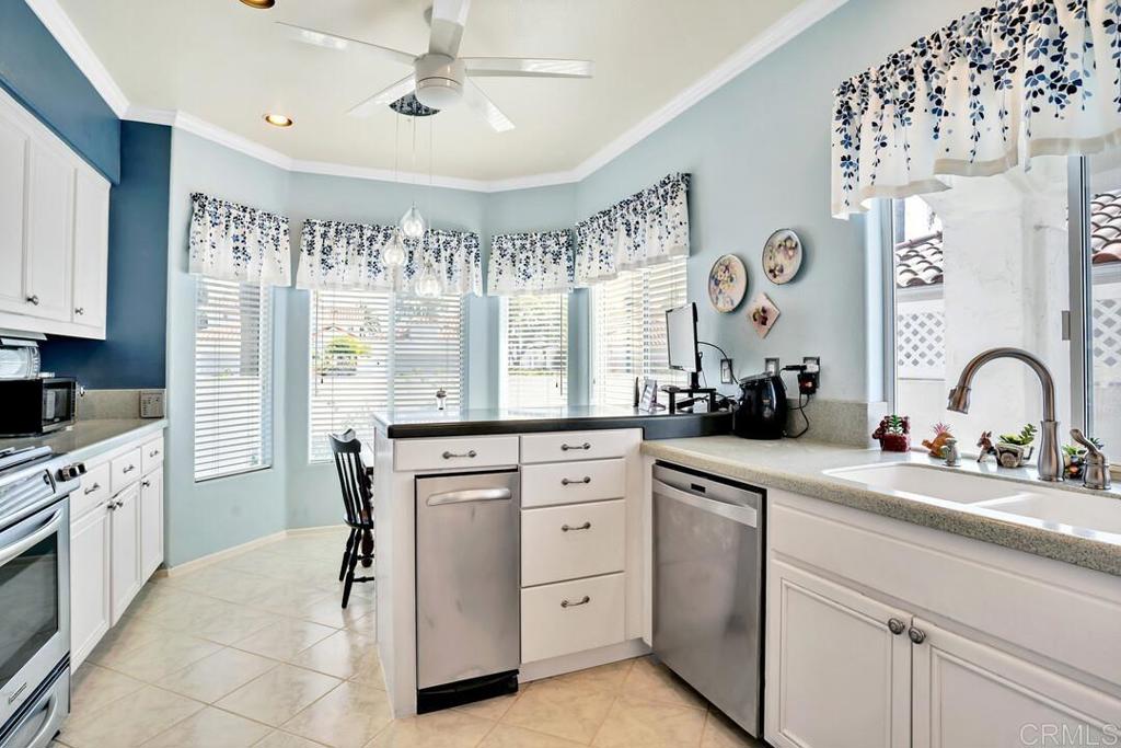4617 Cyrus Way Oceanside, CA 92056 - Photo 4 of 63 a kitchen with white cabinets and white appliances