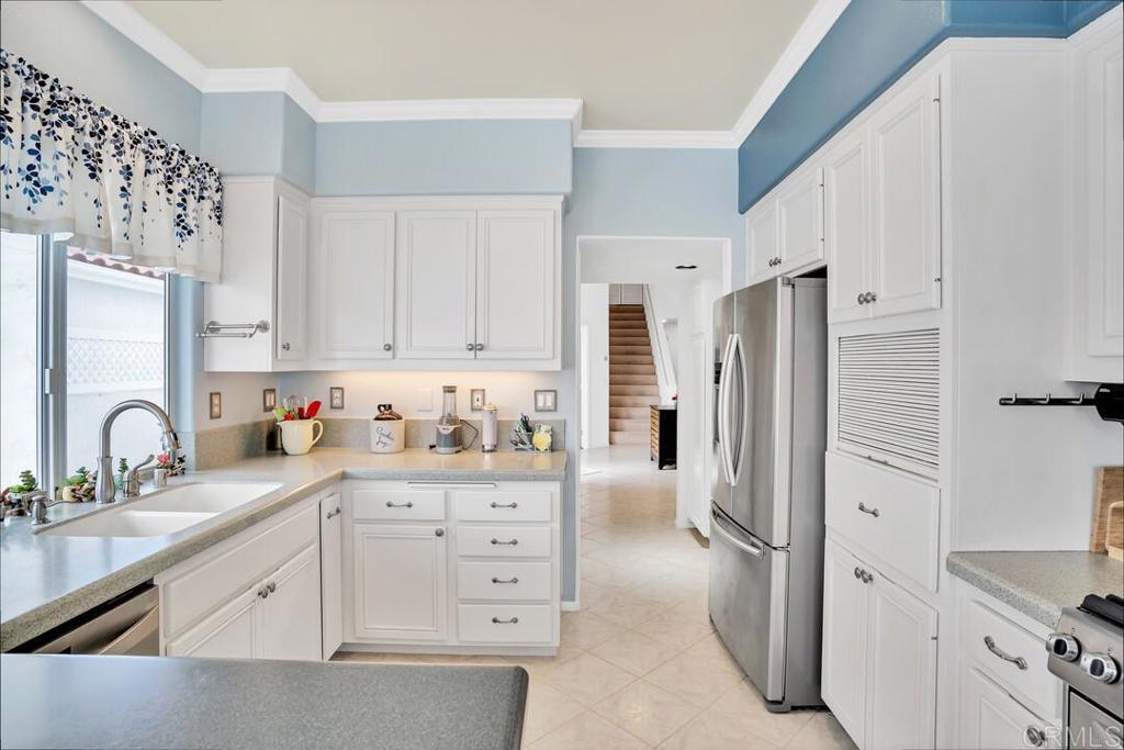 4617 Cyrus Way Oceanside, CA 92056 - Photo 6 of 63 a kitchen with granite countertop a refrigerator sink and cabinets