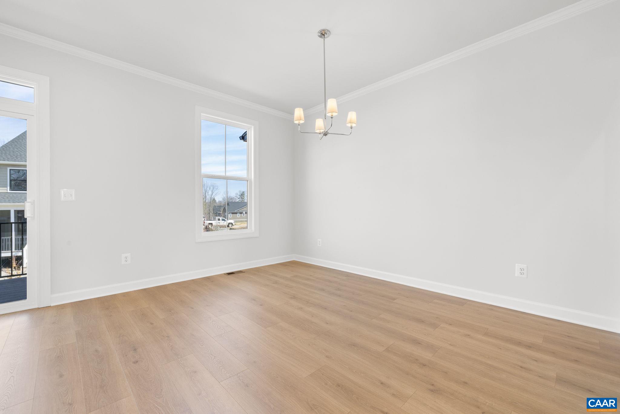 3089 Miranda Crossing Charlottesville, VA 22901 - Photo 29 of 47 an empty room with wooden floor chandelier and windows
