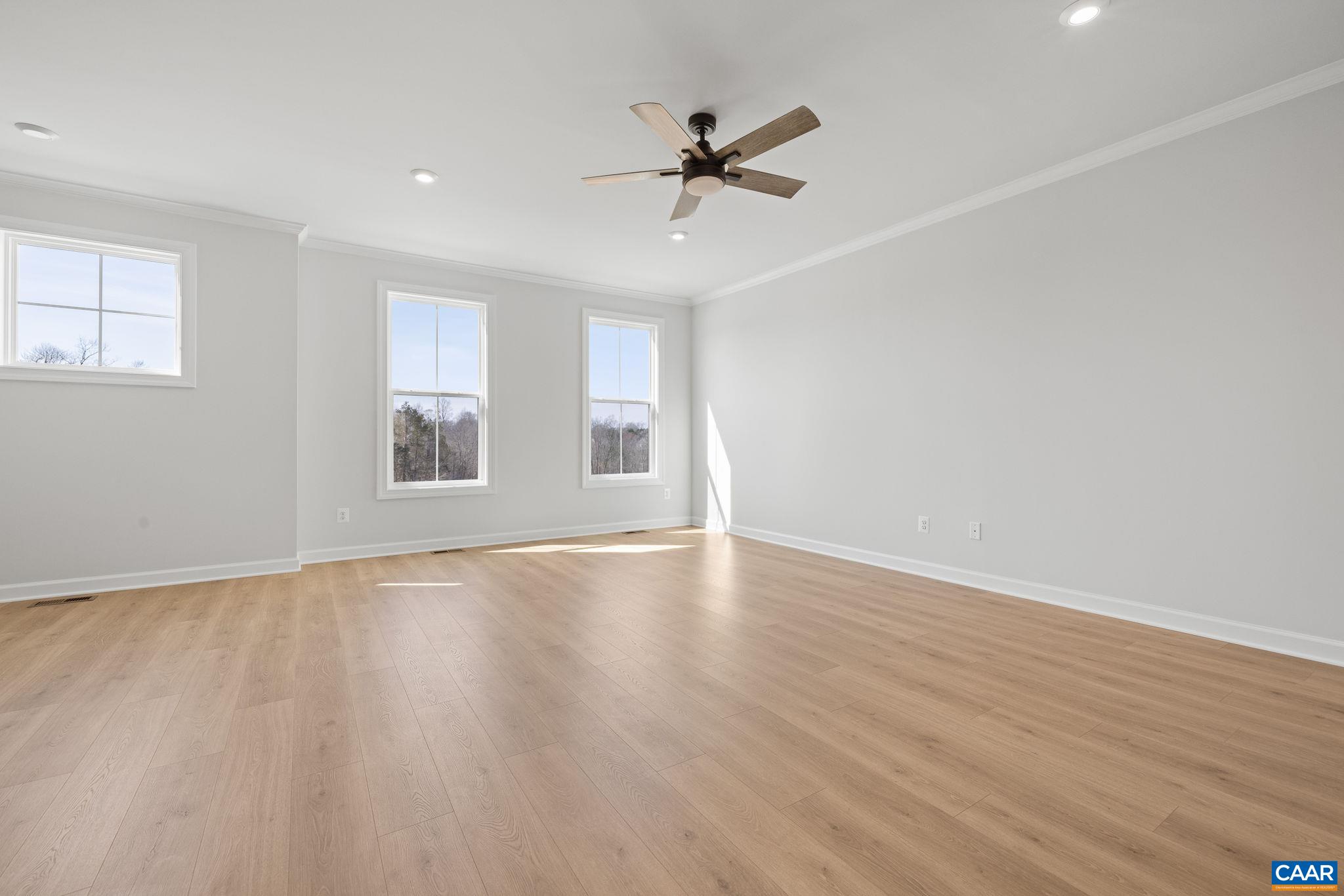 3089 Miranda Crossing Charlottesville, VA 22901 - Photo 35 of 47 an empty room with wooden floor fan and windows