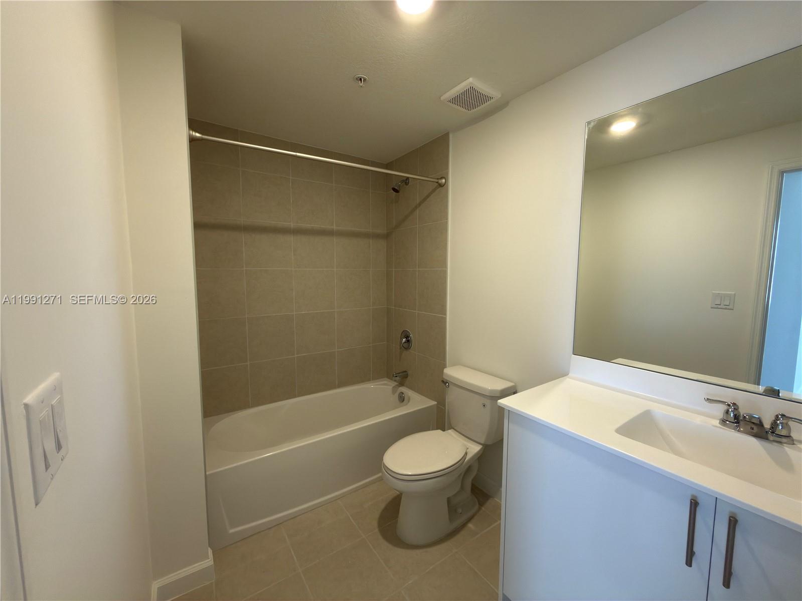 12426 Southwest 248th Street, Unit 1 Homestead, FL 33032 - Photo 11 of 13 a bathroom with a toilet a sink and a bathtub