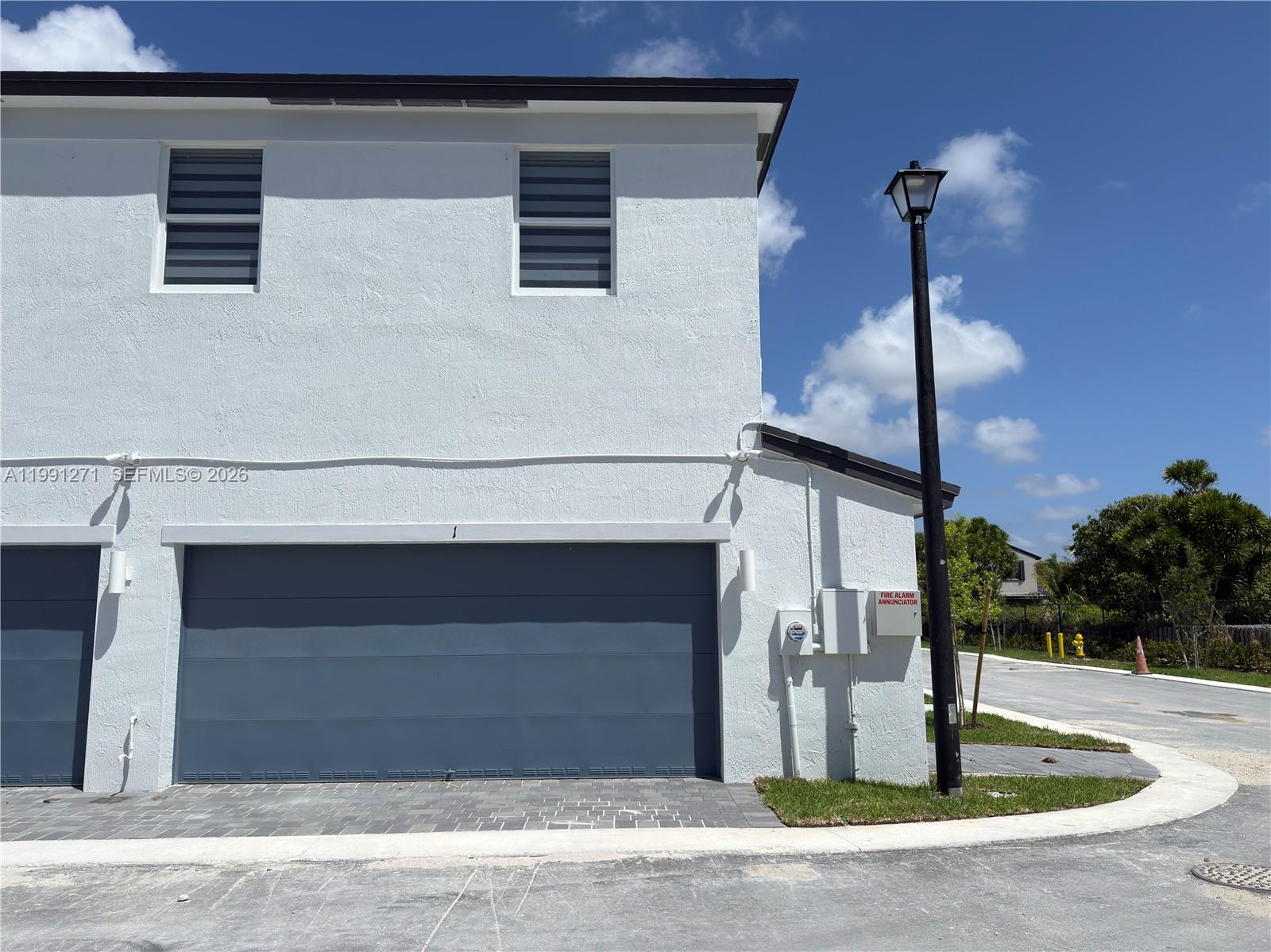 12426 Southwest 248th Street, Unit 1 Homestead, FL 33032 - Photo 2 of 13 a front view of a house with garage