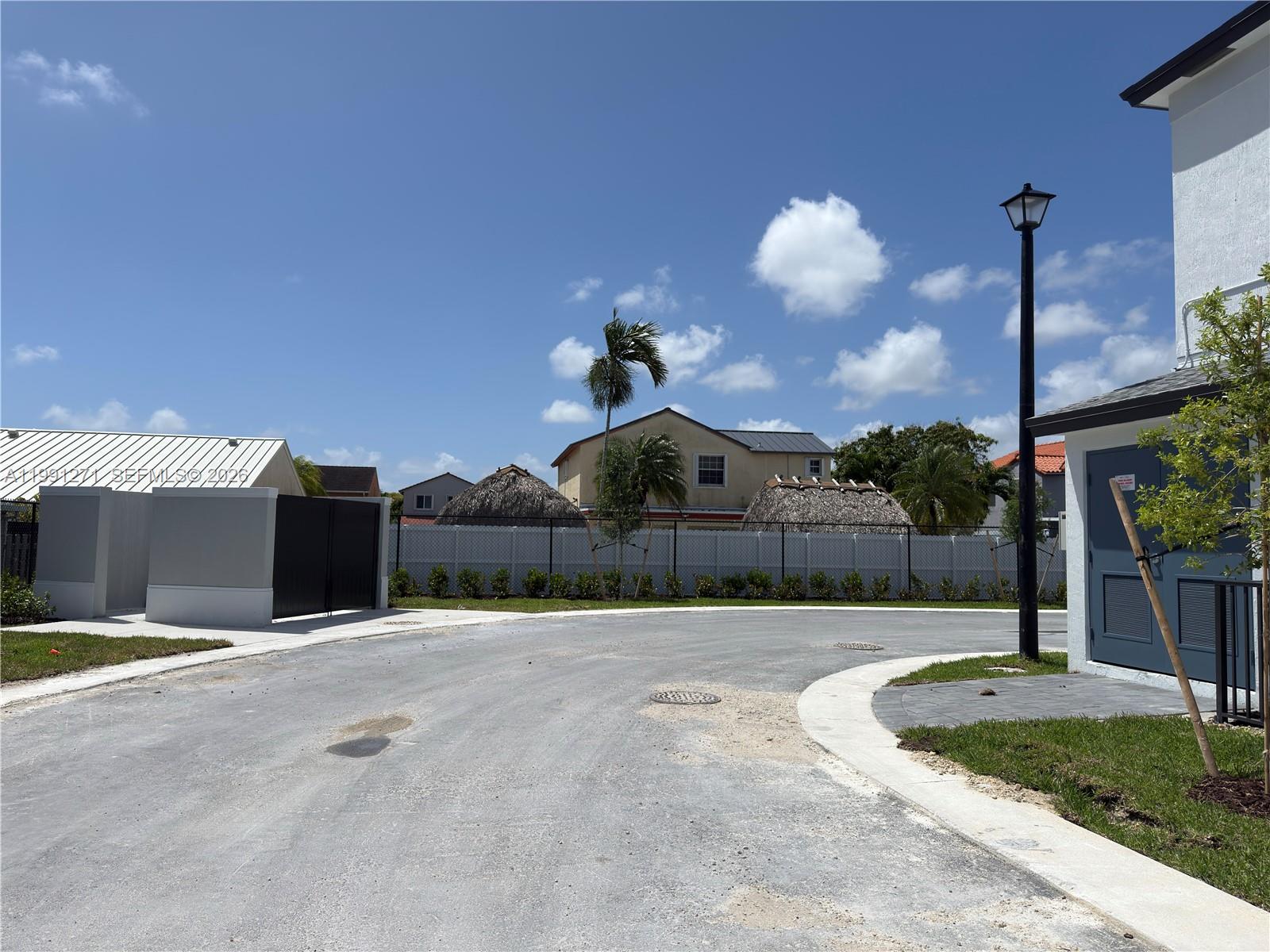 12426 Southwest 248th Street, Unit 1 Homestead, FL 33032 - Photo 4 of 13 a view of a house with a yard and garage
