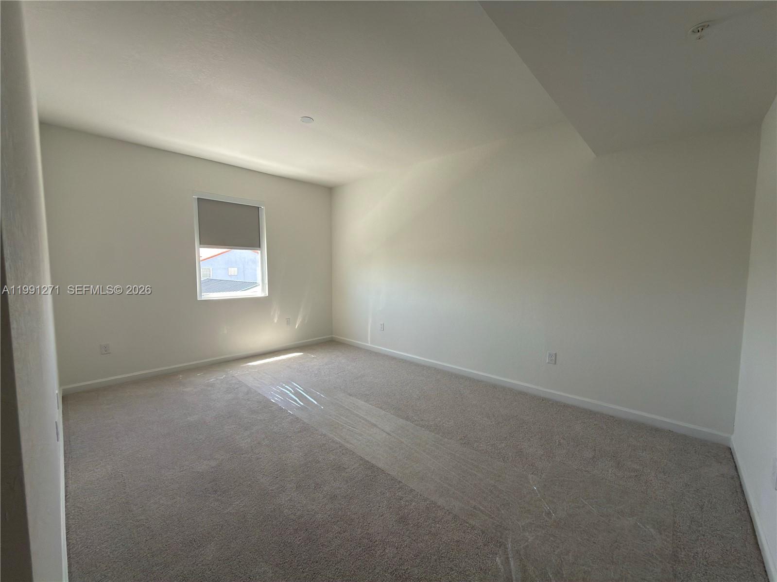 12426 Southwest 248th Street, Unit 1 Homestead, FL 33032 - Photo 10 of 13 an empty room with windows