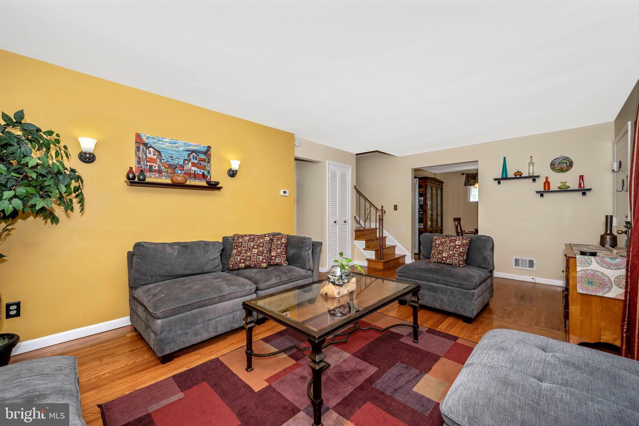 4304 Ridge Avenue Baltimore, MD 21227 - Photo 9 of 50 a living room with furniture a rug and a wall painting