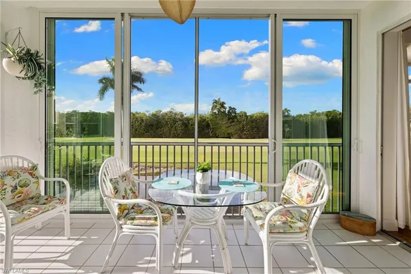 a view of a balcony with table and chairs