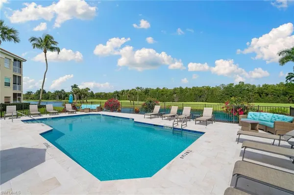 a view of swimming pool with outdoor seating and city view
