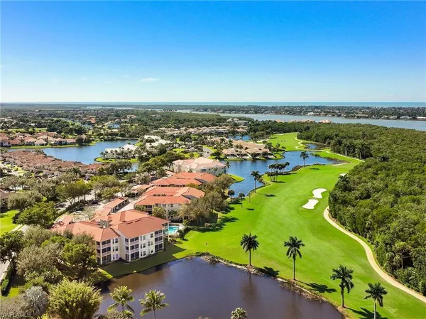 an aerial view of a houses with a lake view