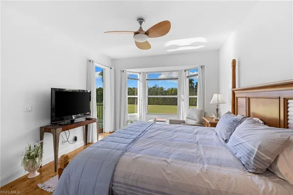 a bedroom with a bed and flat screen tv