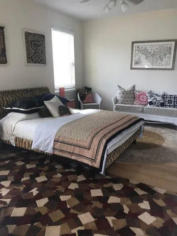 a spacious bedroom with a bed and a couch