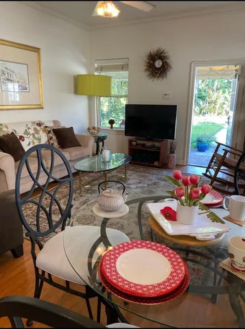 a view of a dining room with furniture and a large window