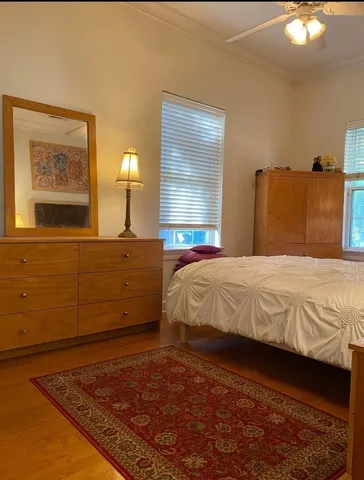 a bedroom with a bed and a mirror