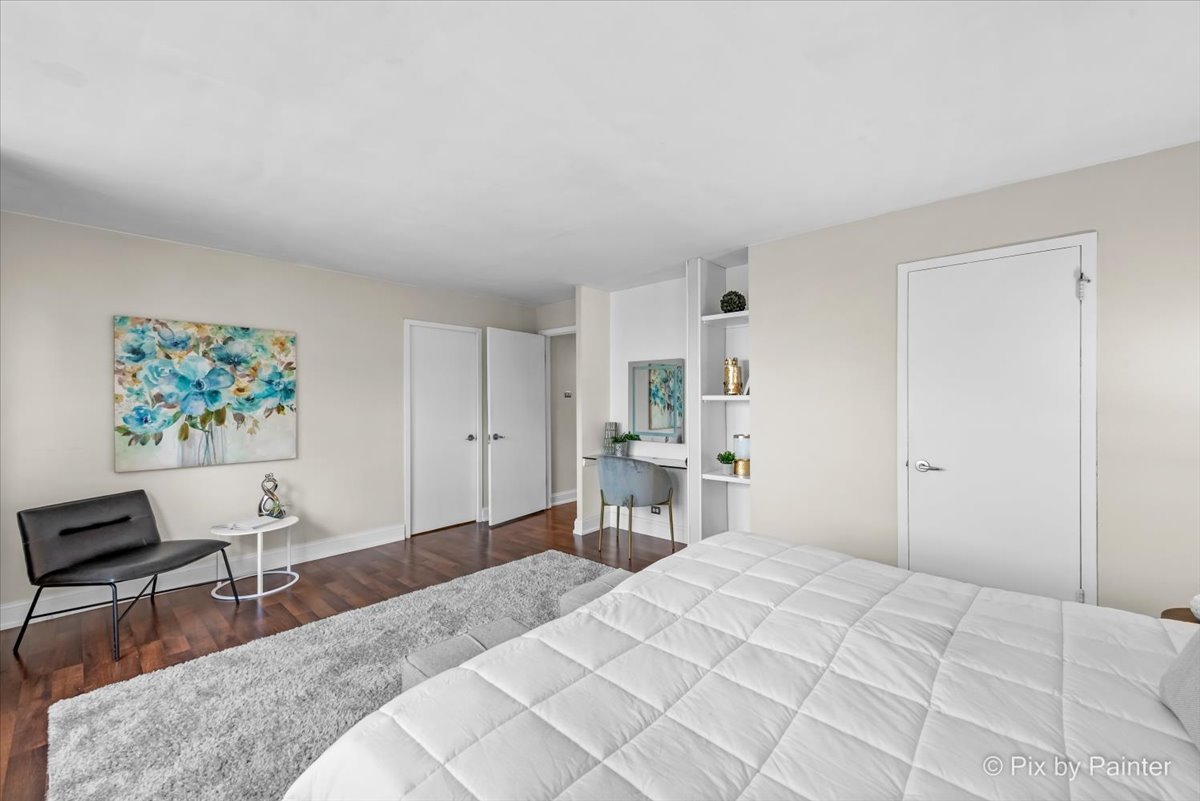 2909 North Sheridan Road, Unit 1507 Chicago, IL 60657 - Photo 11 of 27 a bedroom with a bed and a chair