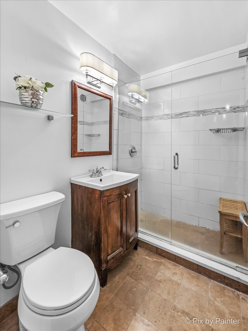 2909 North Sheridan Road, Unit 1507 Chicago, IL 60657 - Photo 12 of 27 a bathroom with a toilet sink and shower