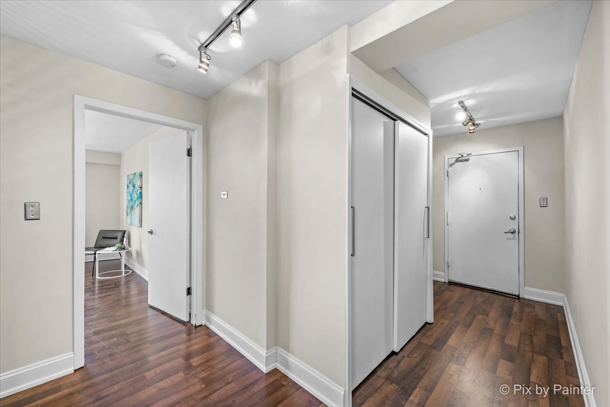 2909 North Sheridan Road, Unit 1507 Chicago, IL 60657 - Photo 14 of 27 a view of a hallway with wooden floor