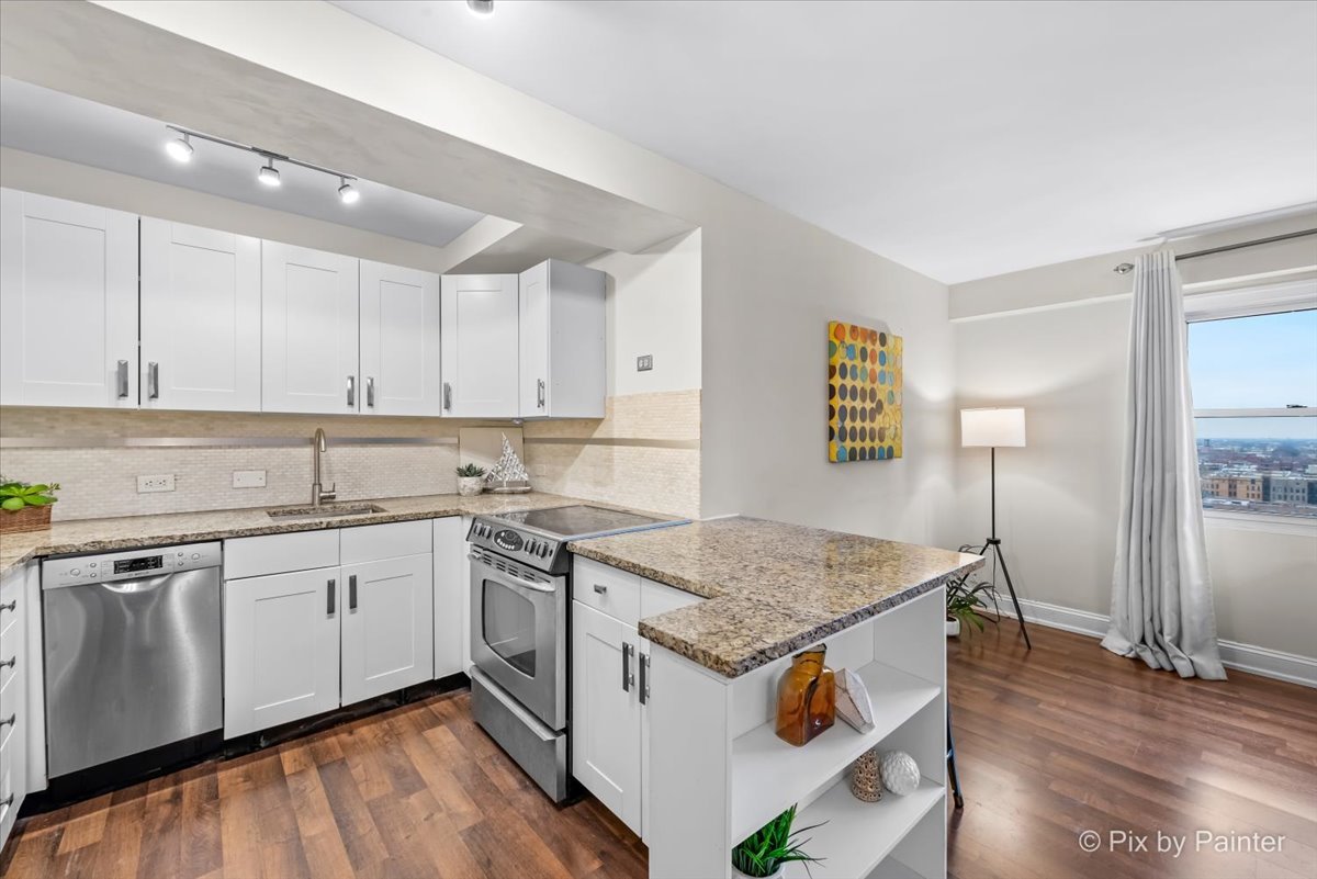 2909 North Sheridan Road, Unit 1507 Chicago, IL 60657 - Photo 6 of 27 a kitchen with a sink stove and refrigerator