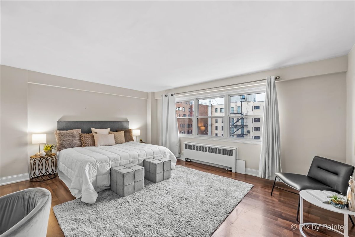 2909 North Sheridan Road, Unit 1507 Chicago, IL 60657 - Photo 10 of 27 a bedroom with a bed and a couch