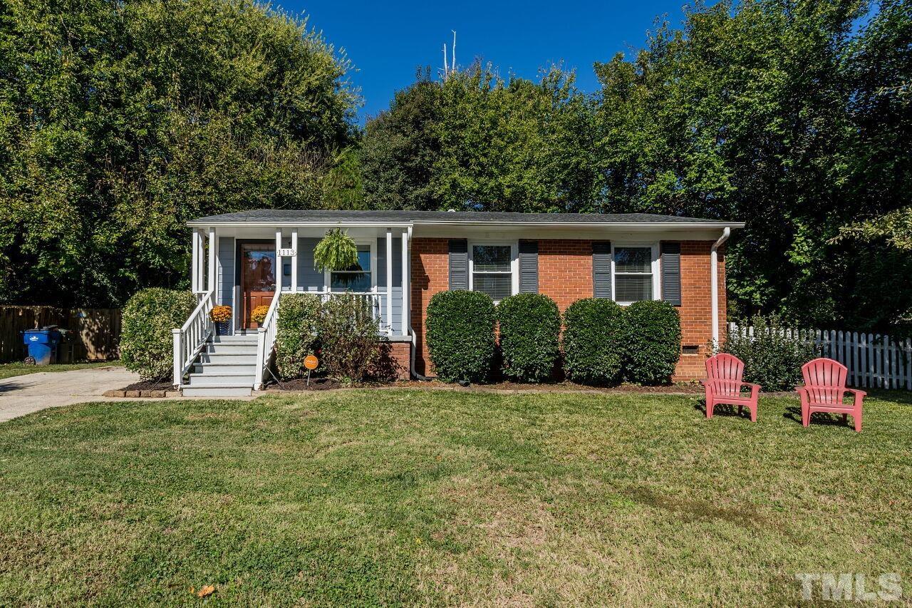 1113 North King Charles Road Raleigh, NC 27610 - Photo 1 of 24 a view of a house with backyard and garden