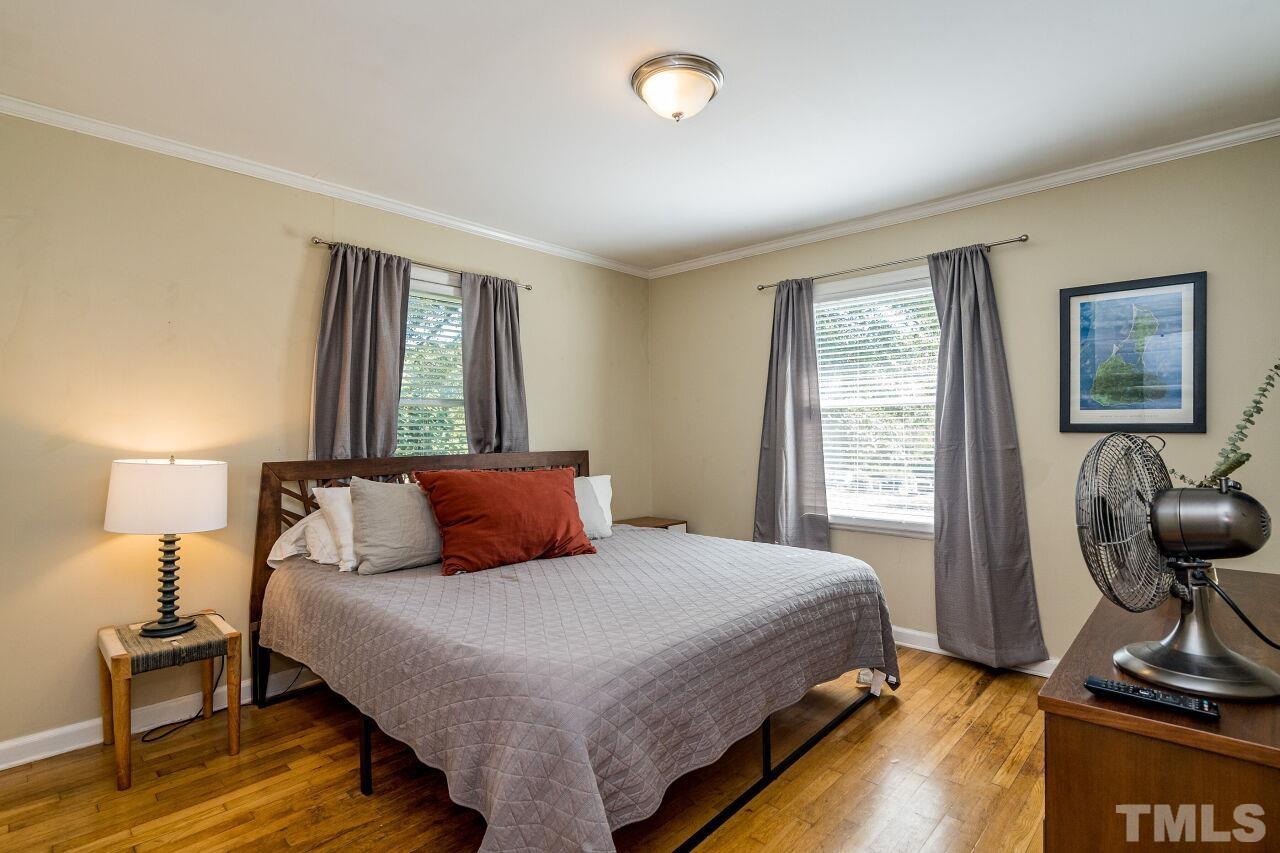 1113 North King Charles Road Raleigh, NC 27610 - Photo 12 of 24 a bedroom with a bed and wooden floor
