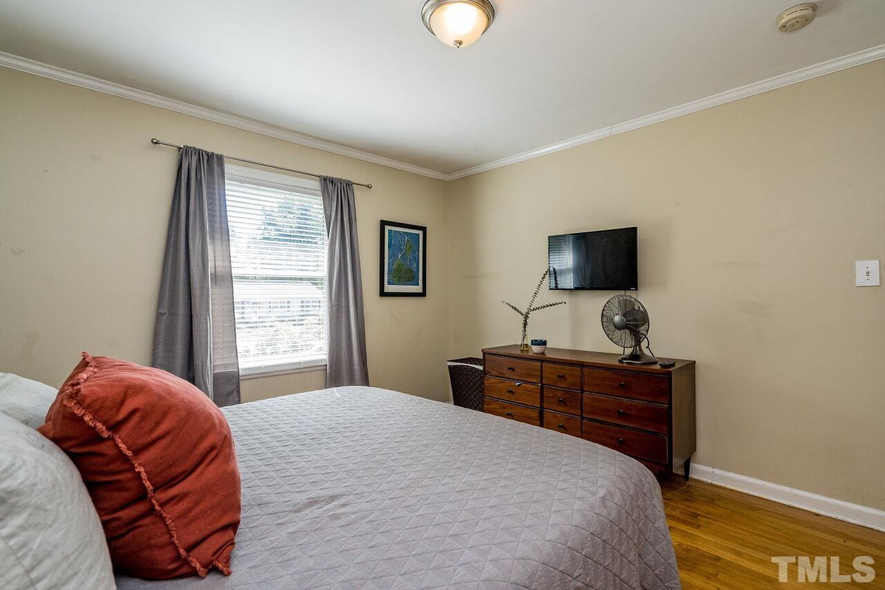 1113 North King Charles Road Raleigh, NC 27610 - Photo 13 of 24 a bedroom with a bed and window