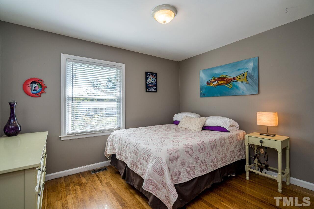 1113 North King Charles Road Raleigh, NC 27610 - Photo 15 of 24 a bedroom with a bed and a window