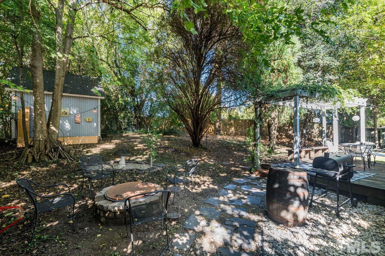 1113 North King Charles Road Raleigh, NC 27610 - Photo 19 of 24 a backyard of a house with table and chairs