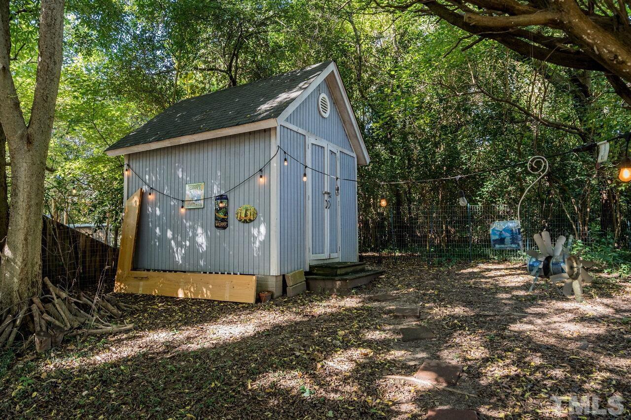 1113 North King Charles Road Raleigh, NC 27610 - Photo 20 of 24 a view of a house with backyard and trees