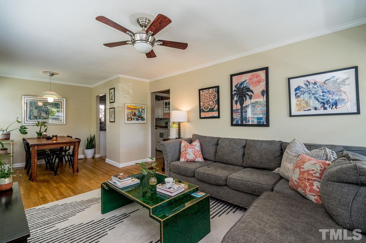 1113 North King Charles Road Raleigh, NC 27610 - Photo 3 of 24 a living room with furniture a rug and a dining table