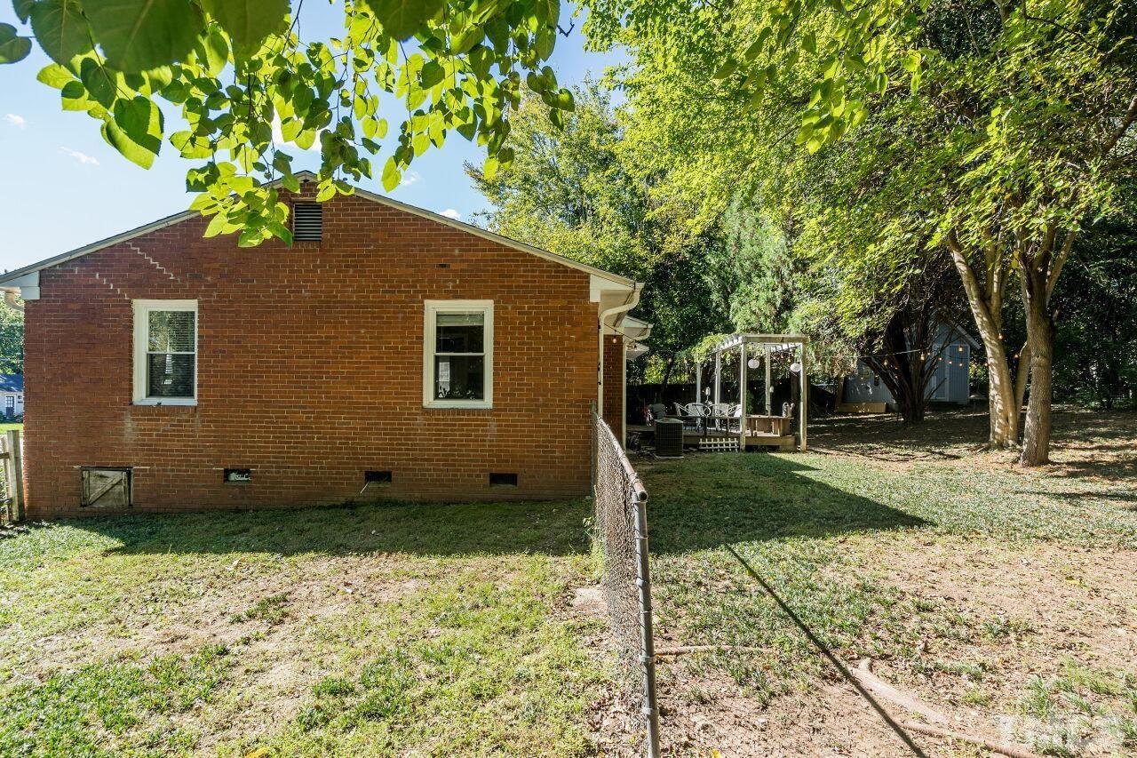 1113 North King Charles Road Raleigh, NC 27610 - Photo 21 of 24 a backyard of a house with table and chairs