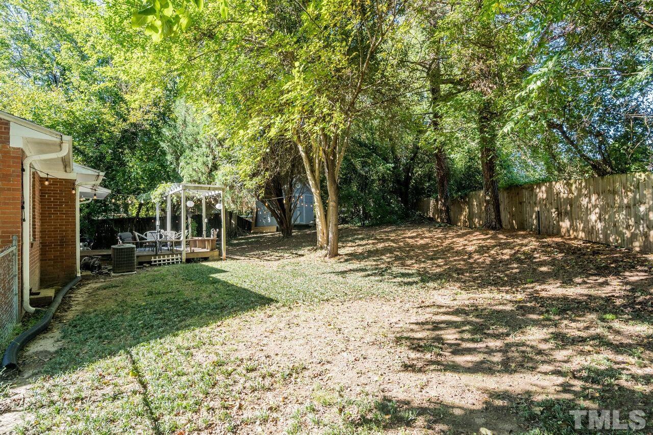 1113 North King Charles Road Raleigh, NC 27610 - Photo 22 of 24 a backyard of a house with table and chairs