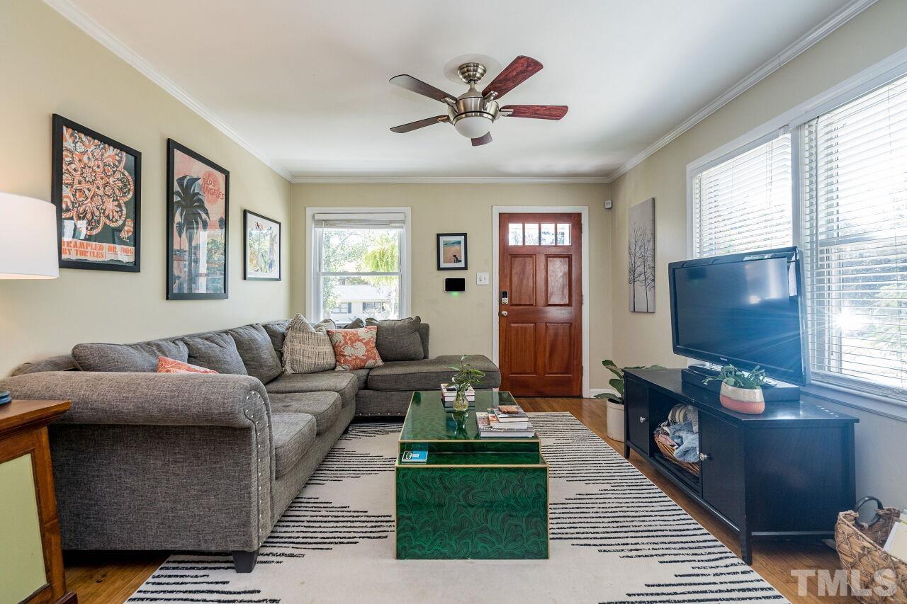 1113 North King Charles Road Raleigh, NC 27610 - Photo 5 of 24 a living room with furniture and a flat screen tv