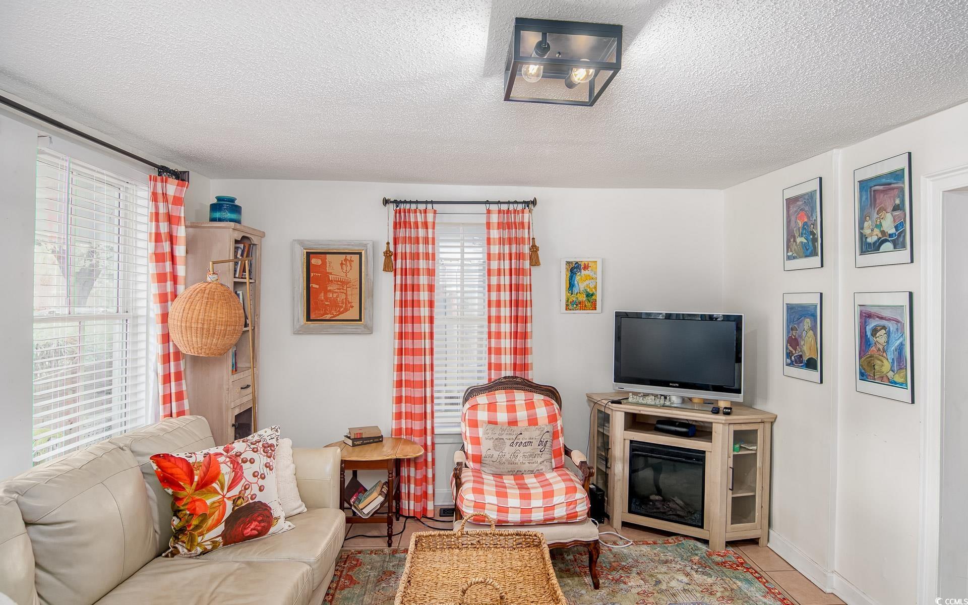 423 Highmarket Street Georgetown, SC 29440 - Photo 6 of 25 Tiled living area with a textured ceiling and baseboards