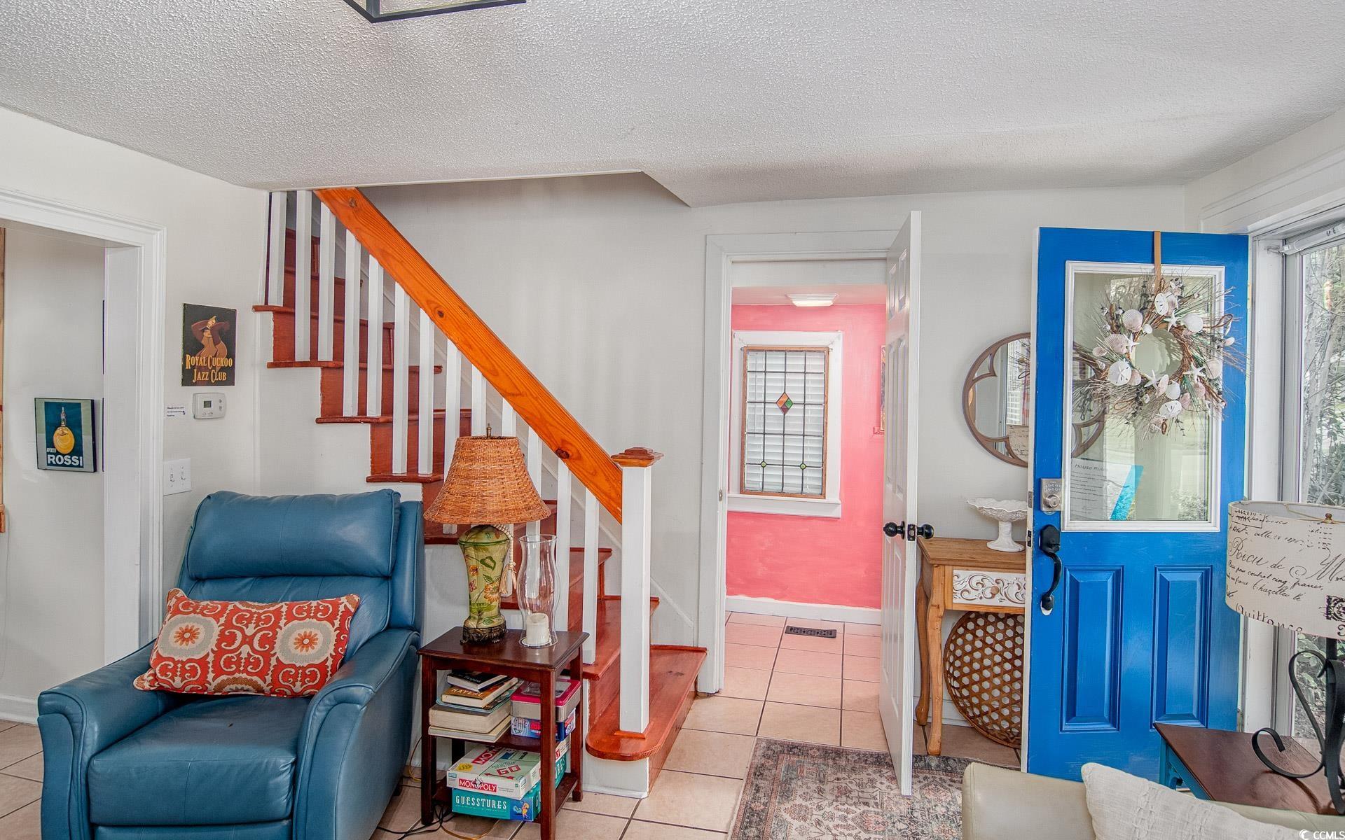 423 Highmarket Street Georgetown, SC 29440 - Photo 7 of 25 Stairs featuring tile patterned floors, a textured ceiling, and plenty of natural light