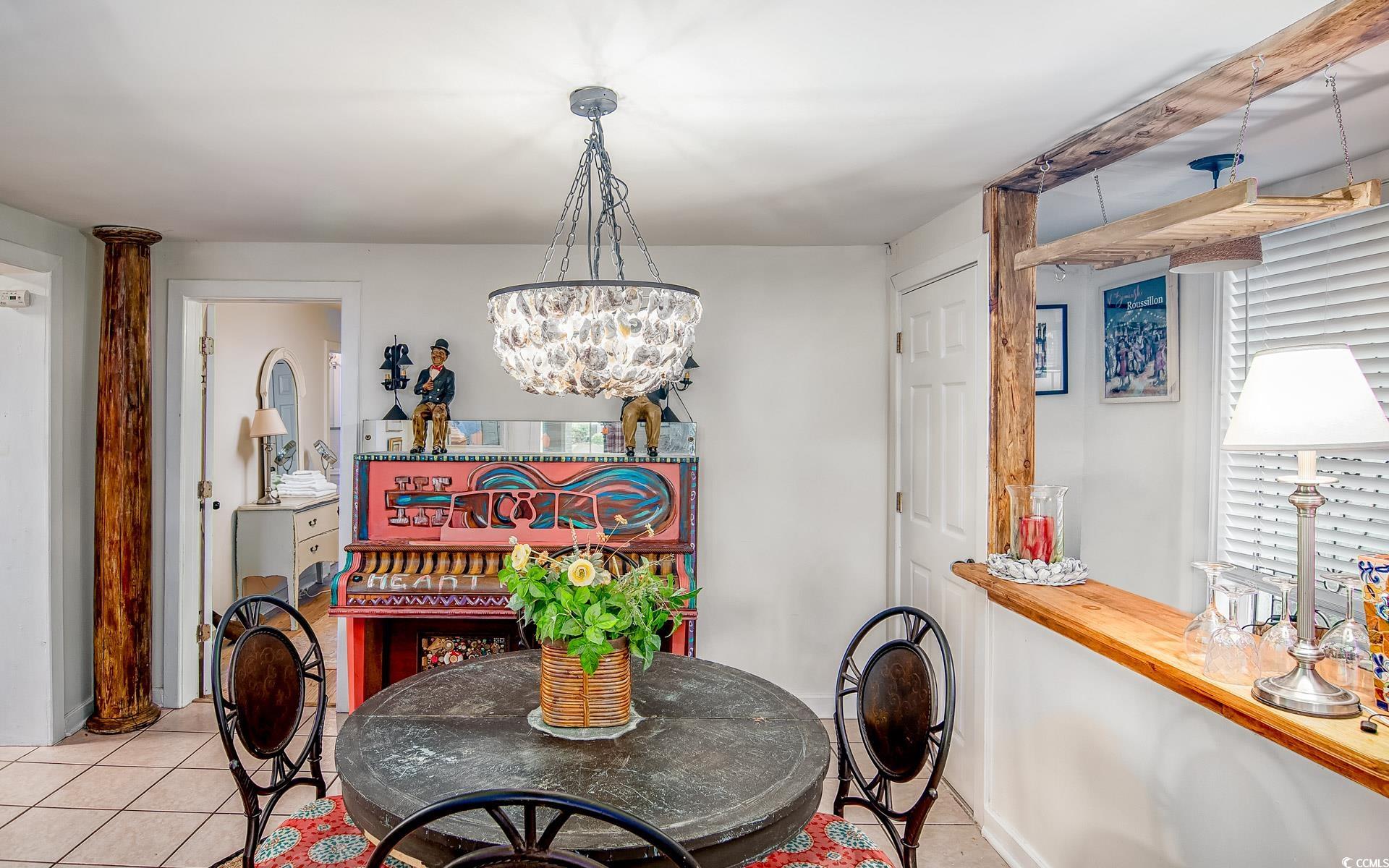 423 Highmarket Street Georgetown, SC 29440 - Photo 9 of 25 Dining room featuring tile patterned flooring and a chandelier
