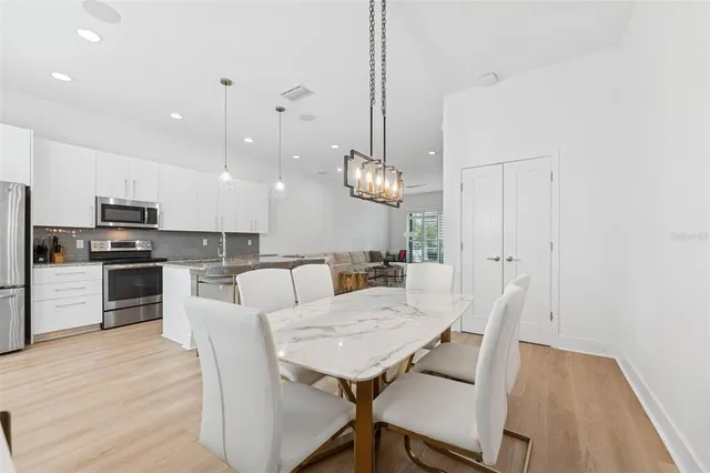 a view of a dining room with furniture and wooden floor