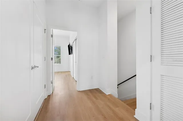 a view of a hallway with wooden floor