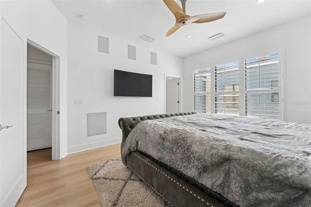 a bedroom with a bed and a flat screen tv