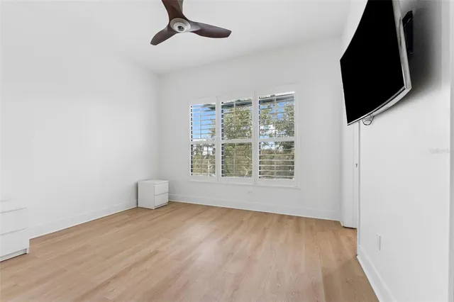 a view of an empty room with wooden floor