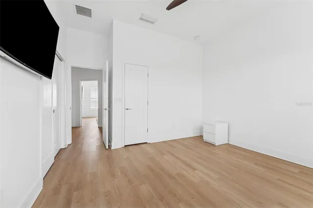 a bathroom with a granite countertop toilet sink and mirror