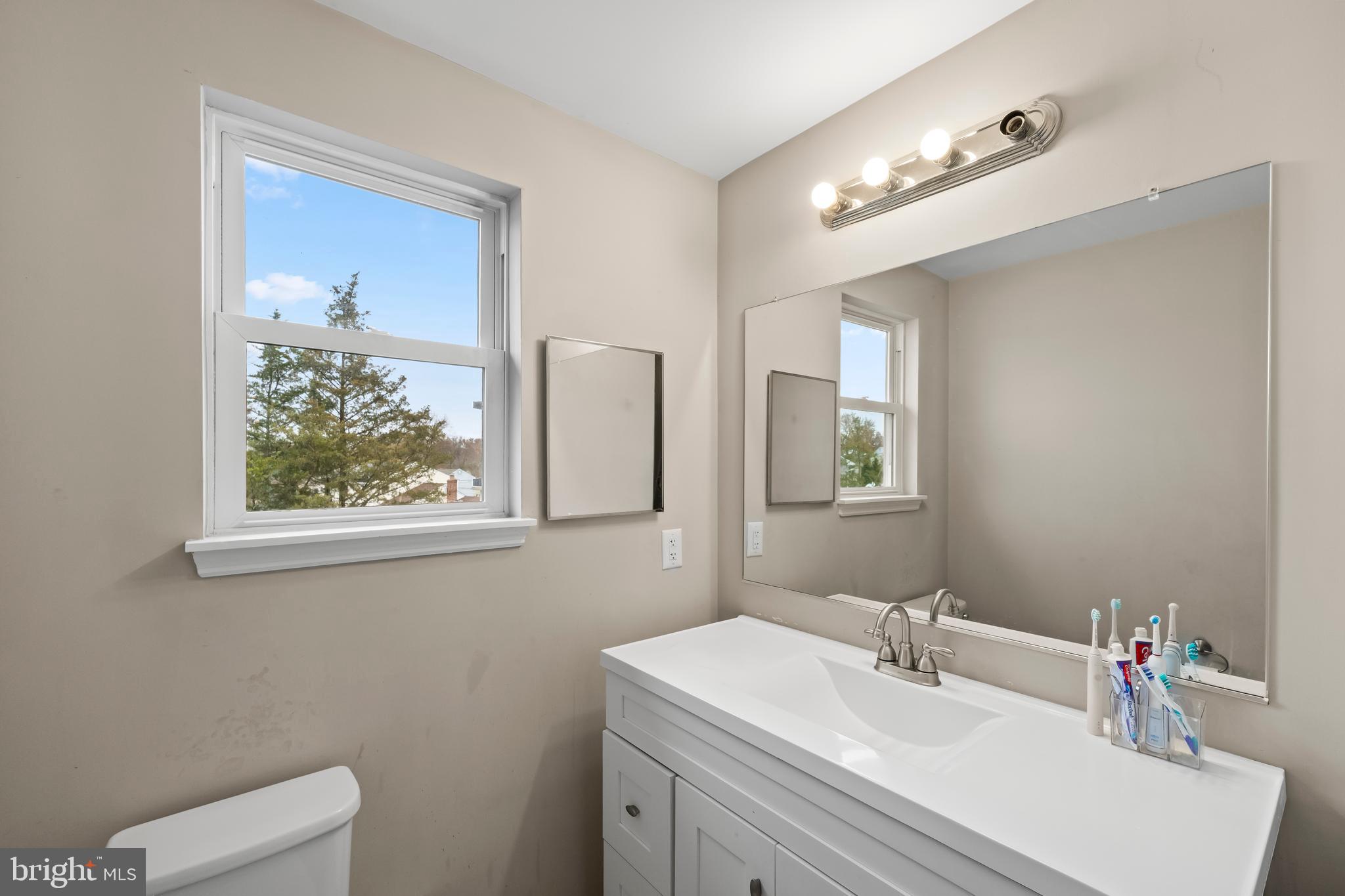 208 Pelham Road South Voorhees, NJ 08043 - Photo 19 of 33 a bathroom with a sink vanity and a mirror