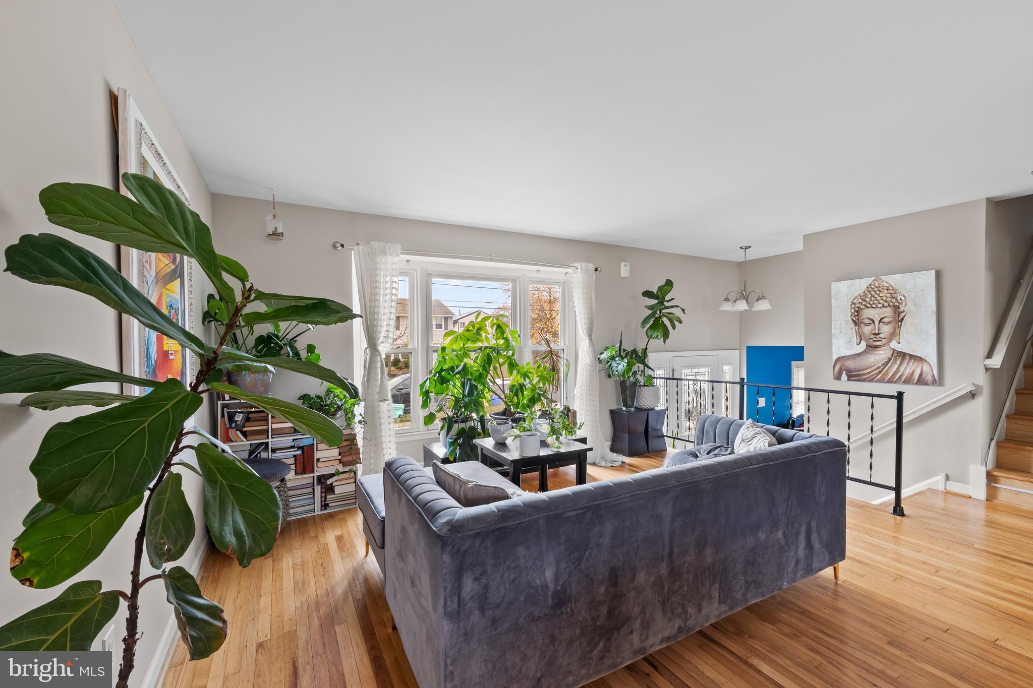 208 Pelham Road South Voorhees, NJ 08043 - Photo 7 of 33 a living room with furniture potted plant and a wooden floor