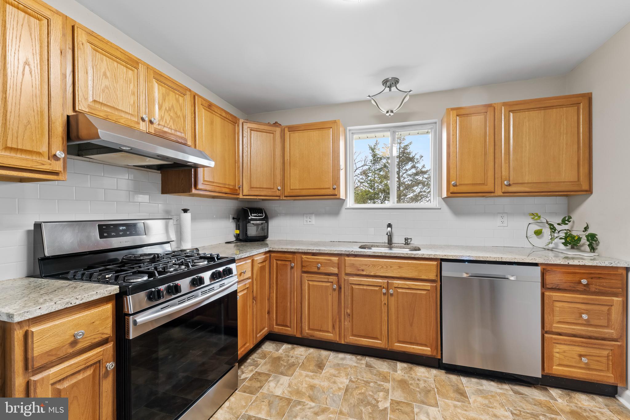 208 Pelham Road South Voorhees, NJ 08043 - Photo 8 of 33 a kitchen with stainless steel appliances granite countertop a sink a stove cabinets and wooden floor