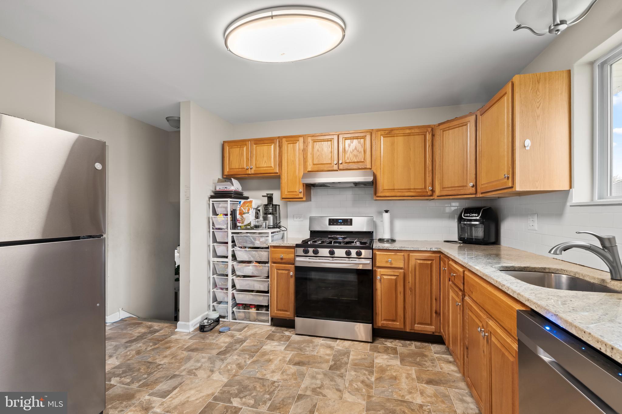 208 Pelham Road South Voorhees, NJ 08043 - Photo 9 of 33 a kitchen with stainless steel appliances granite countertop a stove a refrigerator and a sink