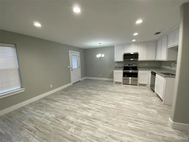 a view of kitchen with microwave and stove