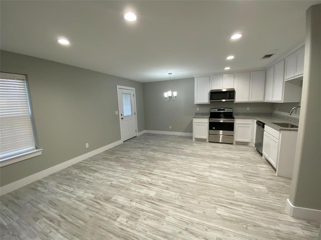 131 East Bond Street Denison, TX 75021 - Photo 3 of 10 a view of kitchen with microwave and stove