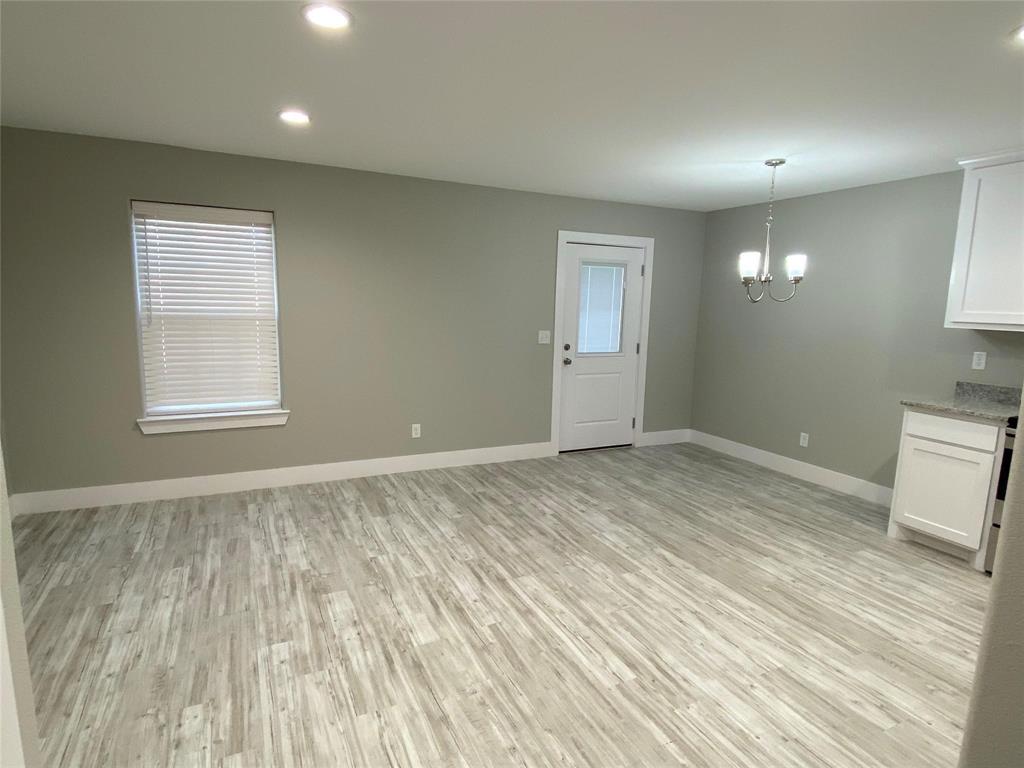 131 East Bond Street Denison, TX 75021 - Photo 4 of 10 a view of empty room with wooden floor and fan