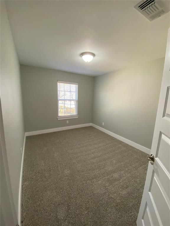 131 East Bond Street Denison, TX 75021 - Photo 5 of 10 an empty room with windows