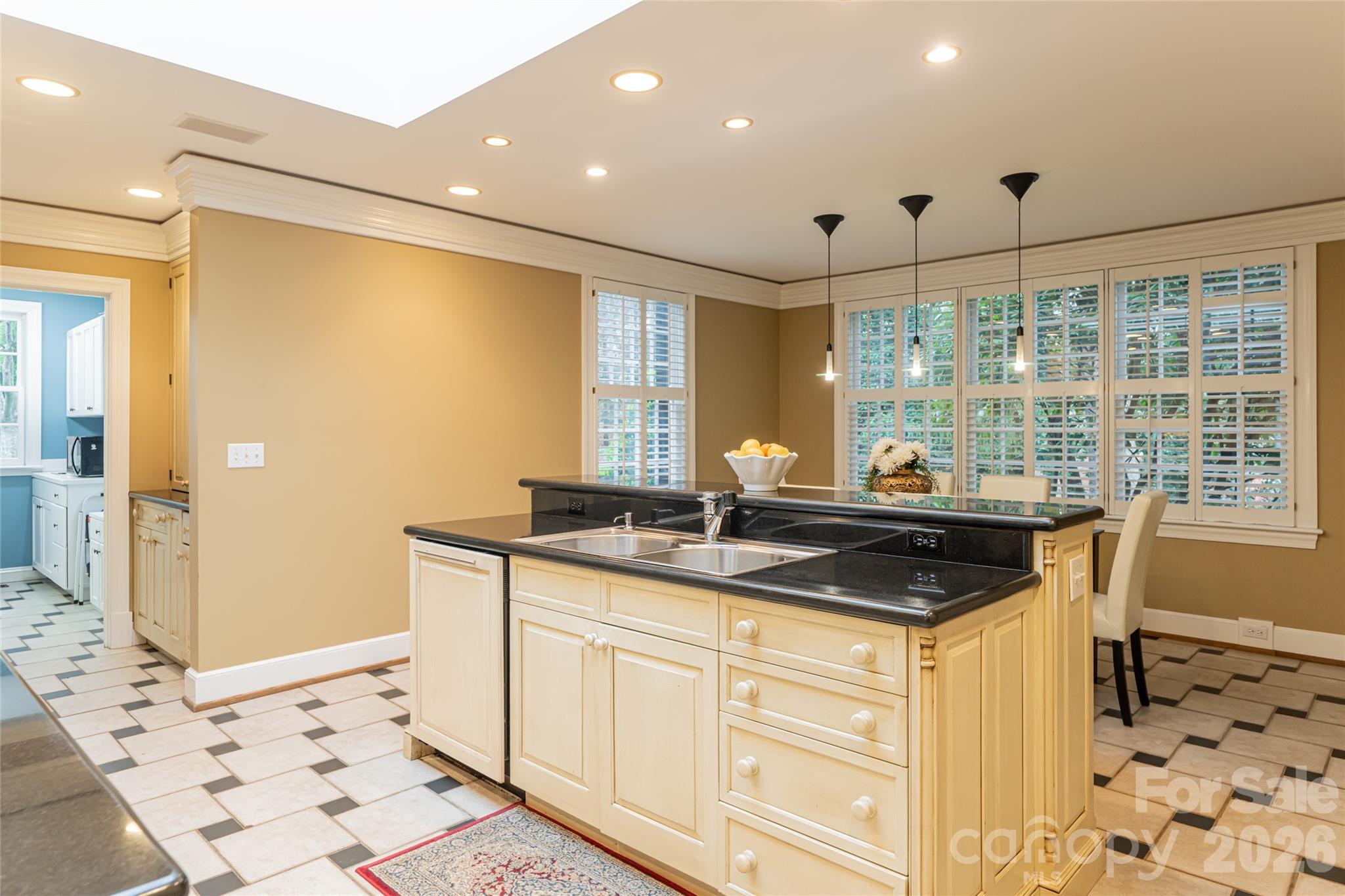 31 Busbee Road Asheville, NC 28803 - Photo 24 of 48 a kitchen with granite countertop a sink and a refrigerator